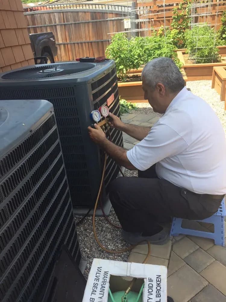 Eli Musayev servicing an outdoor AC condenser — Spark Appliance Repair, Mountain View CA