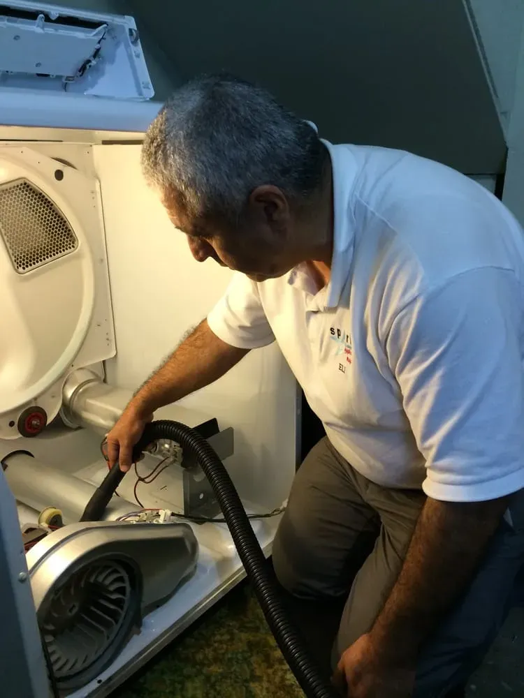 Eli Musayev repairing a dryer from the back — Spark Appliance Repair, Mountain View CA